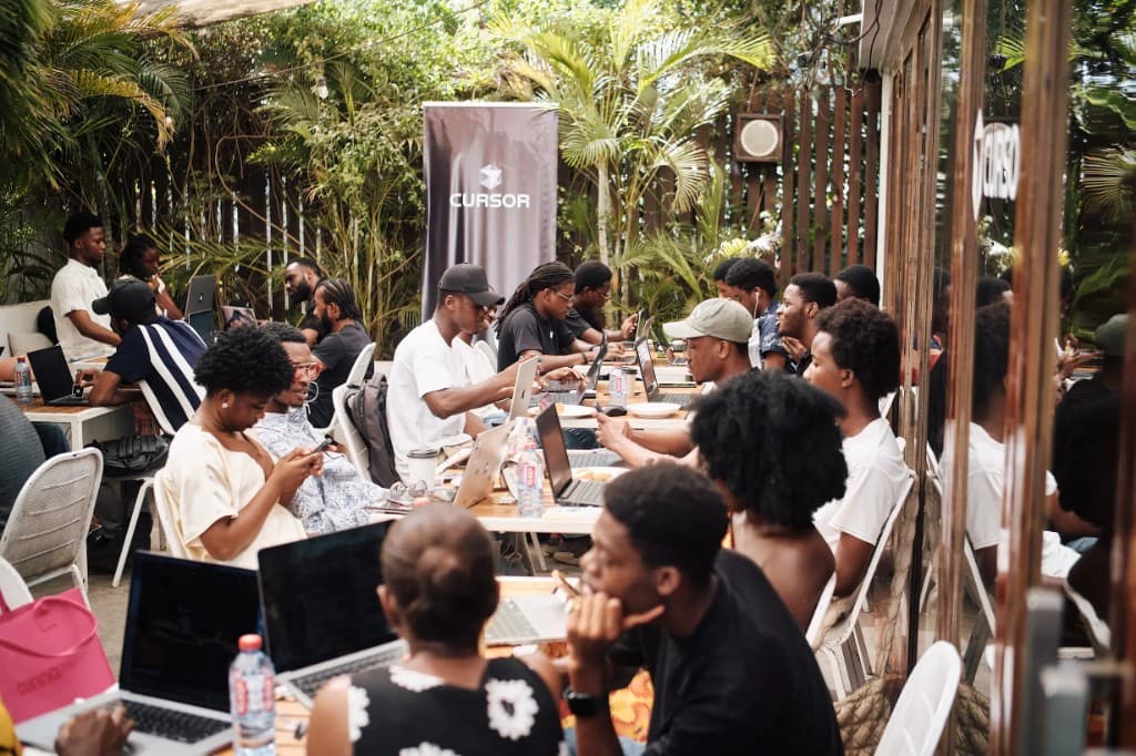 Builders co-working on laptops at Café Cursor in Accra